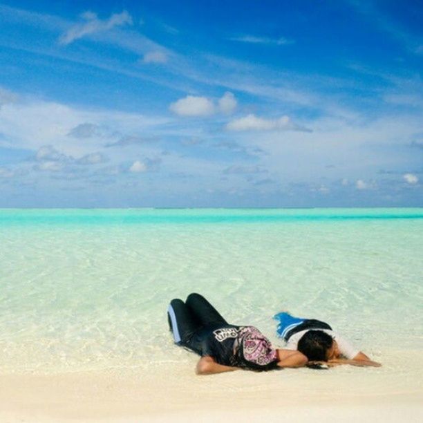 beach, water, sea, sand, blue, shore, sky, tranquility, horizon over water, tranquil scene, relaxation, low section, nature, beauty in nature, one person, scenics, vacations, shoe, day, person