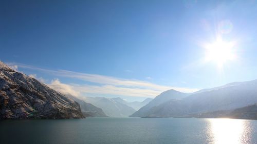 Scenic view of lake and mountains against sky