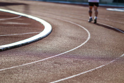Low section of person running on road