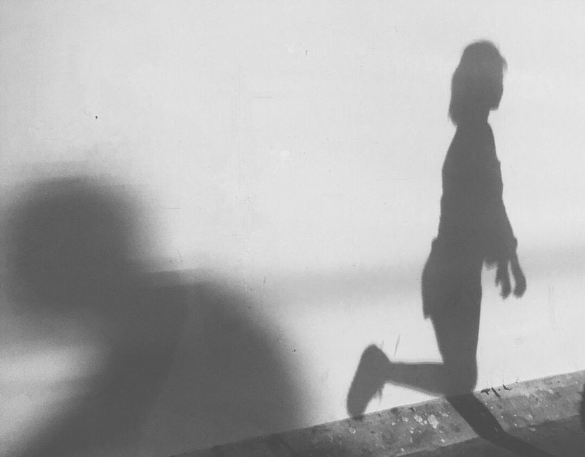 SILHOUETTE WOMAN STANDING BY WATER ON FLOOR