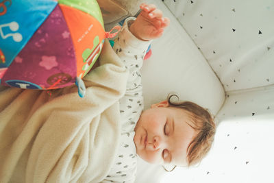 Directly above shot of cute baby sleeping on bed