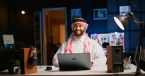 Portrait of young man using digital tablet while sitting in office