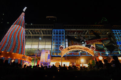 Low angle view of people at night