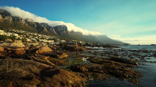 Scenic view of sea and mountains against sky