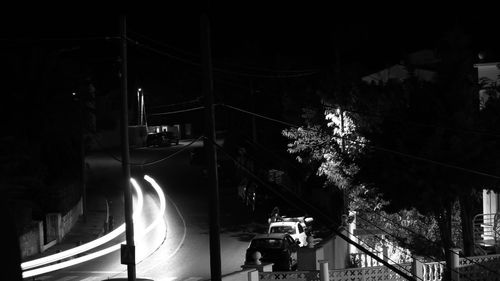 Illuminated light trails on street in city at night