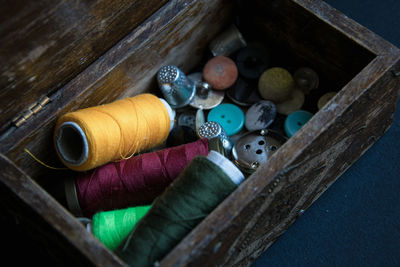 High angle view of sewing items in wooden container