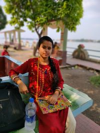 Beautiful lady sitting on river side