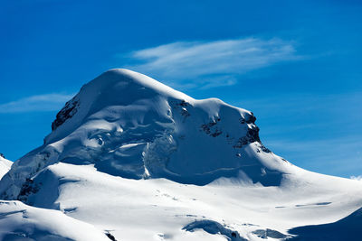 Scenic view of snow covered mountains against sky