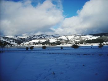 Scenic view of snowcapped mountains against sky