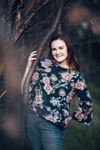 Portrait of smiling young woman standing outdoors