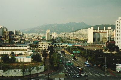 High angle view of city street and buildings against sky