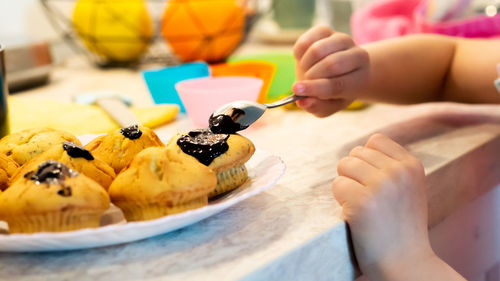 Cropped hand of woman holding cake