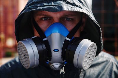 Close-up portrait of man wearing gas mask