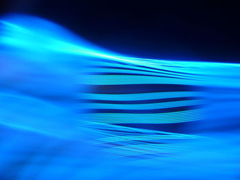 Abstract image of illuminated blue sea over background