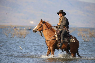 Man riding horse in lake