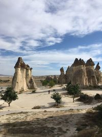 Castle on rock formations against sky