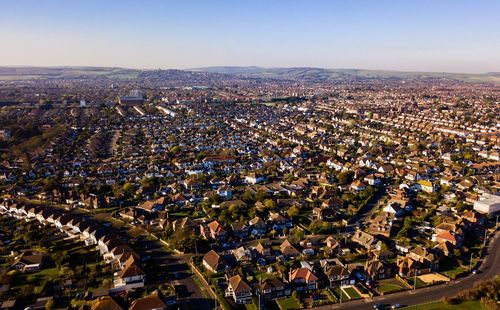 High angle drone shot of townscape against clear sky