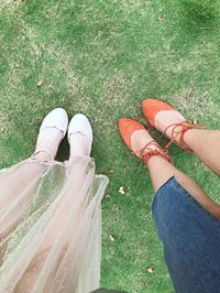 Low section of women standing on field