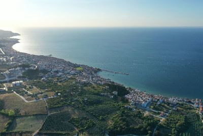High angle view of townscape by sea against sky