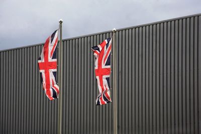 Low angle view of british flag against sky