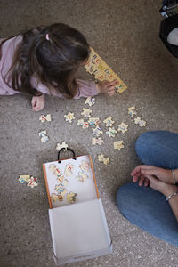 Girl lying on floor and doing jigsaw puzzles