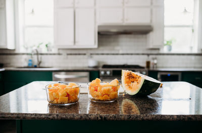 Fresh cut organic orange meat watermelon on counter in modern kitchen