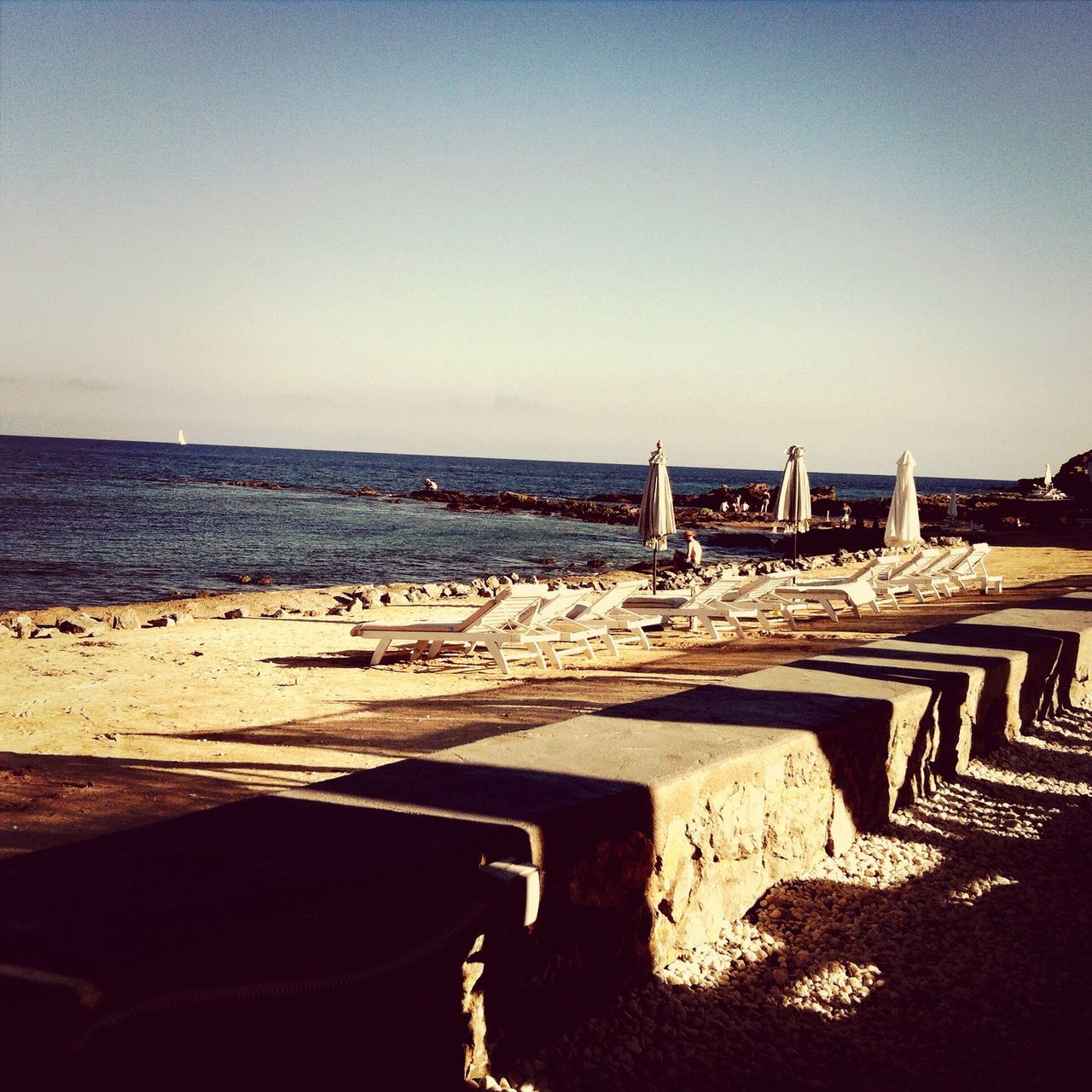 beach, clear sky, sea, sand, copy space, horizon over water, water, shore, tranquil scene, tranquility, scenics, nature, absence, outdoors, wood - material, no people, coastline, day, sunlight, sky