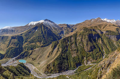 Scenic view of mountains against clear blue sky