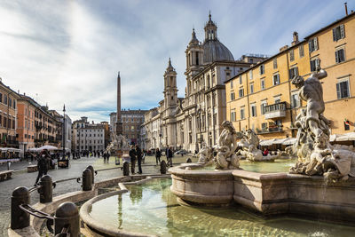 Statue of buildings against sky in city