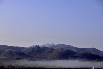 Scenic view of mountains against clear blue sky