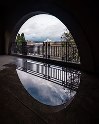 Arch bridge over river against sky