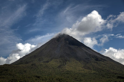 Low angle view of volcanic mountain against sky