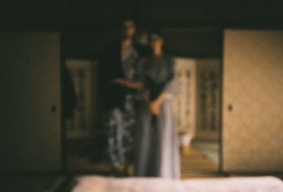 Defocused couple standing inside a minka