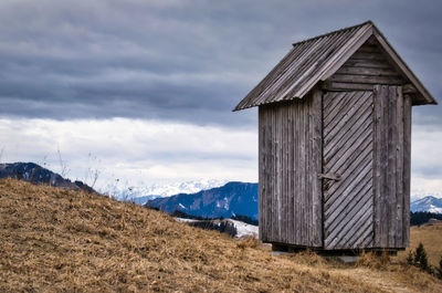 Built structure on field against sky