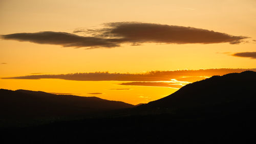 Scenic view of silhouette mountains against sky during sunset