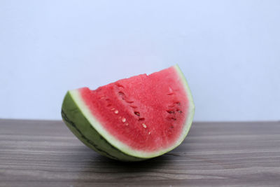 Close-up of strawberry on table against white background