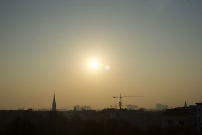 Silhouette of buildings against sky during sunset