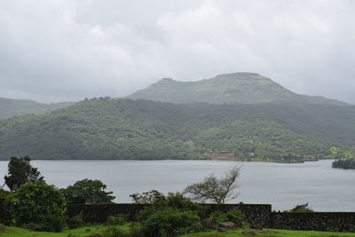 Scenic view of lake and mountains against sky