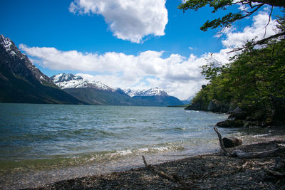 Scenic view of sea and mountains against sky