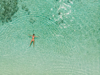 High angle view of woman floating on water
