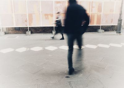 Low section of man walking on floor