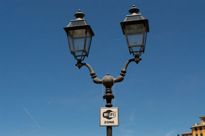 Low angle view of street light against clear blue sky