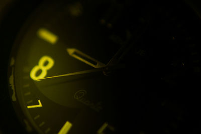 Close-up of clock against black background