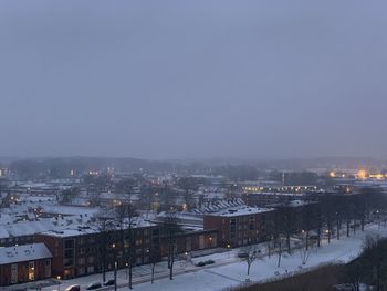 High angle view of illuminated buildings in city during winter