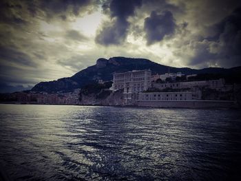 Scenic view of sea and buildings against sky