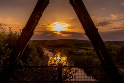 Silhouette bridge against sky during sunset