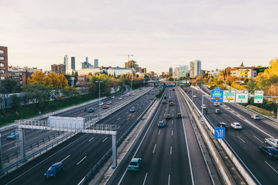 High angle view of vehicles on road in city against sky