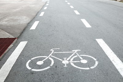 High angle view of arrow symbol on road in city