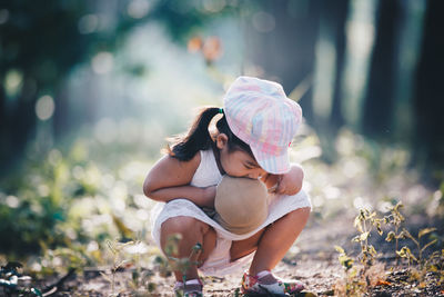 Girl crouching on field