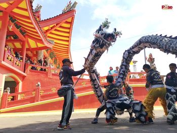 Low angle view of statues against sky